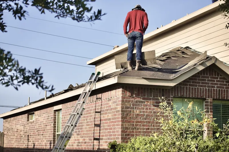 Professional roofer working on a residential roof in Schumacher Place